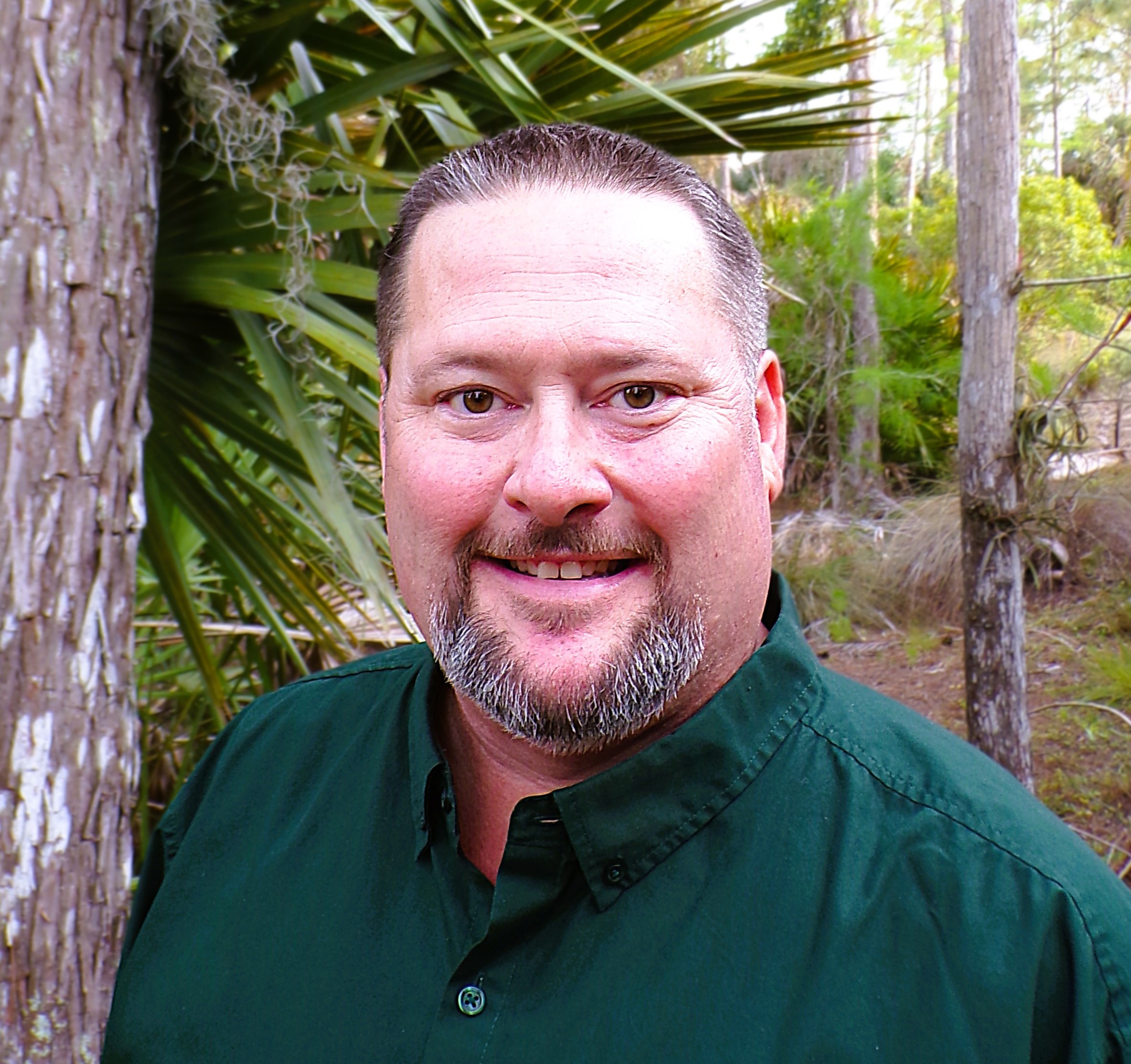 A professional portrait of Timothy Schwan, an environmental specialist with a deep connection to Florida's natural ecosystems. Tim stands confidently, reflecting his expertise and passion for environmental preservation and sustainable progress. The background subtly evokes Florida’s landscapes, with hints of water and greenery, emphasizing his lifelong dedication to protecting the environment.